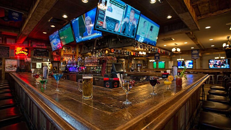Bar area with televisions and drinks